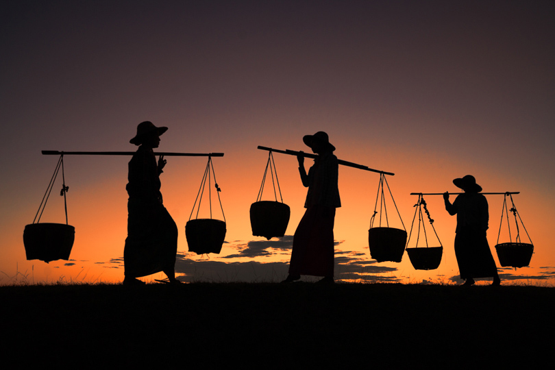 Silhouette of women with baskets