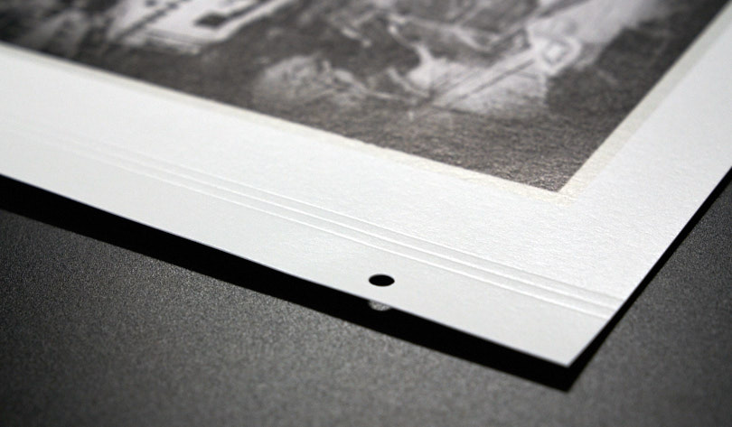 This show the pre-drilled holes as well as the scoring on the paper to make folding easier when viewing in the album