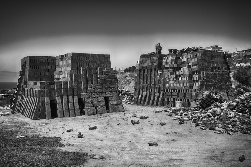 The sun cured bricks are stacked in a very particular way and the interior is filled with coconut husks. Each layer dries at a particular hardness depending upon their end use.