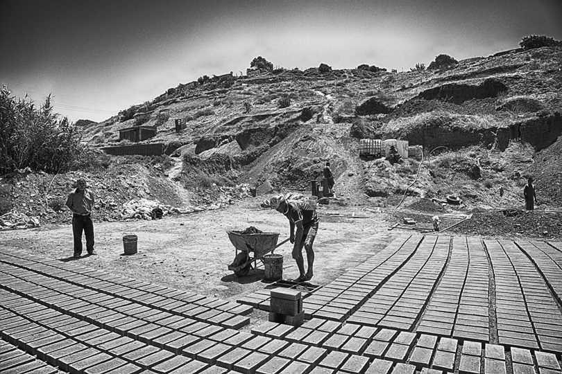 The crew in the pit making bricks.