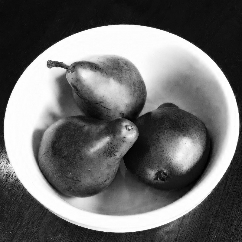 still life with three pears in a bowl