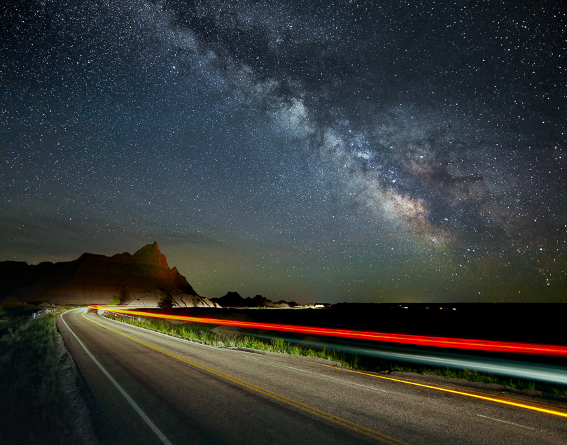 Streaks of light from our car create an interesting foreground that leads to the Milky Way. The sky was exposed separately from the foreground to allow for tracking stars and a different exposure.