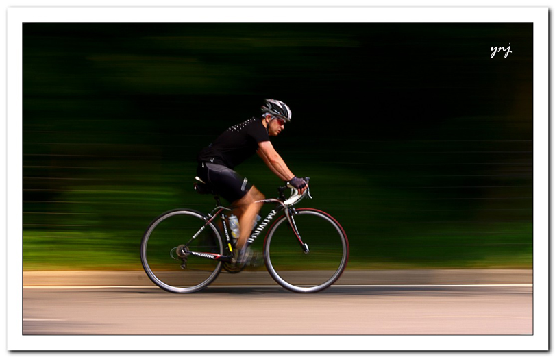 "Central Park Rider" Another way to transform complex backgrounds into a pleasing accentuating space is to pan your camera on a moving object.