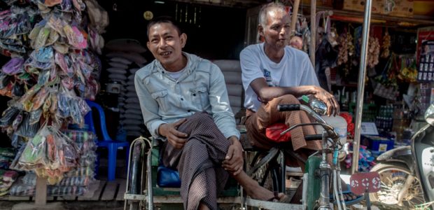 Shot with DXO ONE Camera. Men at the Trishaw, at Pyinmana Market, NayPyiTaw. The Trishaw is a three-wheeled rickshaw that is hugely popular for local transport across Myanmar.