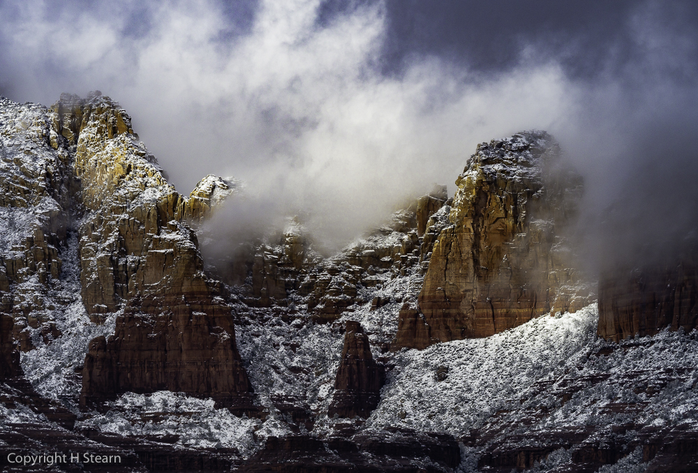 Sunlight breaks through scattering low clouds near Soldier’s Pass