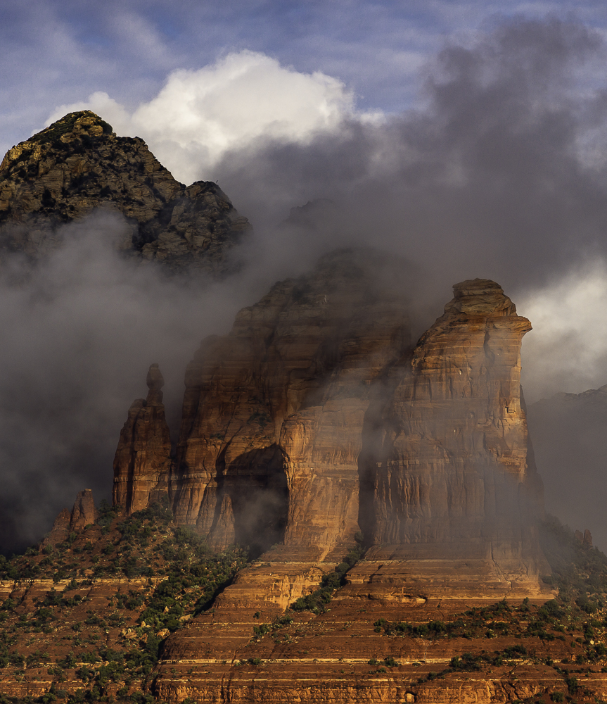 Morning sun illuminates Coffeepot Rock as fog lifts