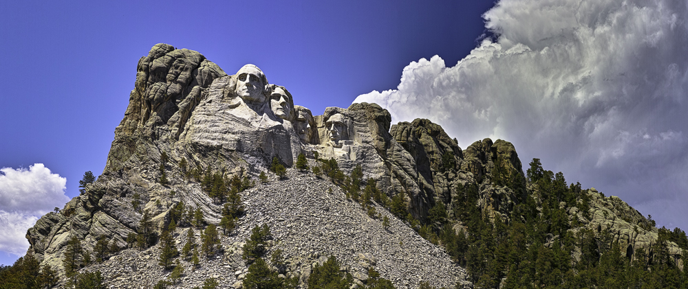 Mount Rushmore and huge cumulus cloud on opposing diagonals