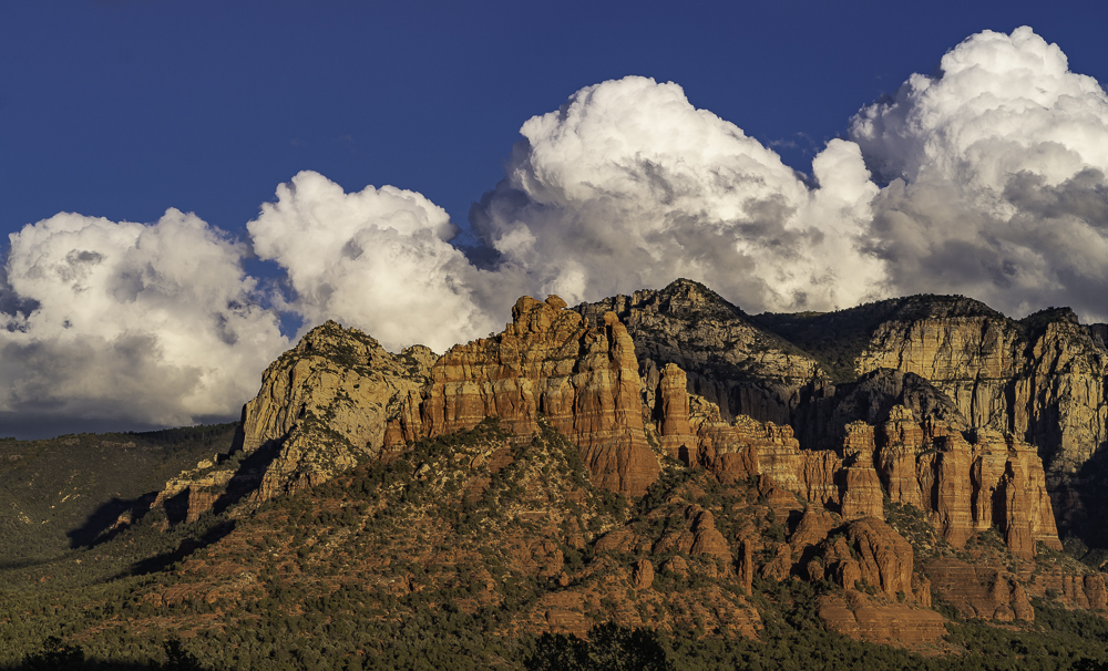 Procession of four identical cumulous clouds over Mogollon Rim