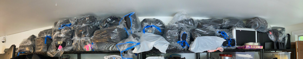 A pano shot of the top selves in my garage. Each of those plastic bags has a camera bag or pack in it. Another sign of serious GAS issues.
