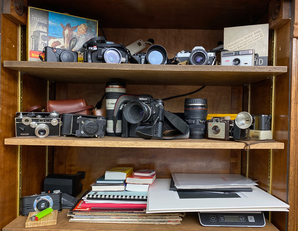 A small portion of my old camera collection as well as prints and books