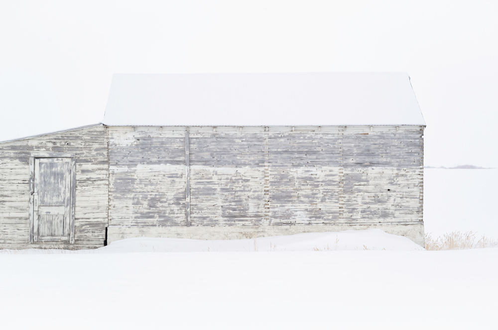 Wendel Wirth (USA) Wood III from the series “This is the Place” In the winter months, the muted horizon parades elemental forms; barns and grain elevators, cow houses, cowsheds, granges as they have been called. https://www.wendelwirth.com/