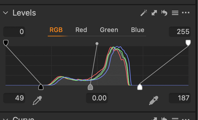 You can see the histogram shows the majority o=f image dat is center. This is typical for this kind of scene. So, I remapped it setting new white and black points as well as off centering the mid point a bit.