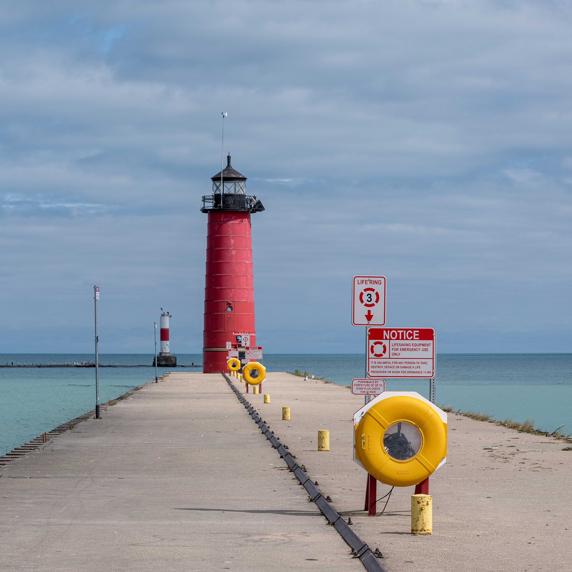 This image took about 45-minutes to make. I did not want the life preserver rings to overlap. There were people in the vicinity. At the time I liked the second image much more than the first one—that may no longer be the case. I resisted using it because it didn’t project the sense of calm and safety I wanted at the end of the narrative. Too much concrete and not enough water.