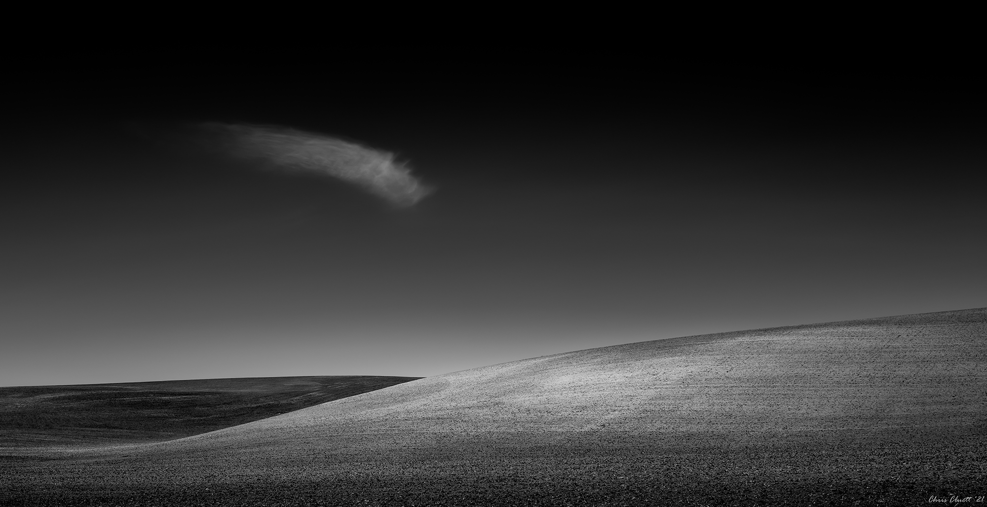 Elegant clouds complemented the patterns in the hills, creating a mysterious echo.