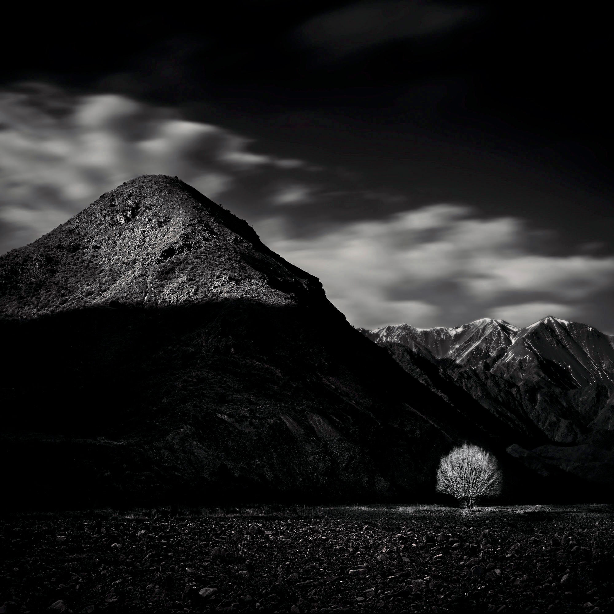 So, why is this balanced? One view is there a small patch of light tree in a dark background, balanced by the mountain peak on the left. There is also an implied diagonal line joining the mountain to the tree - the side of the mountain 'points' to the tree below.