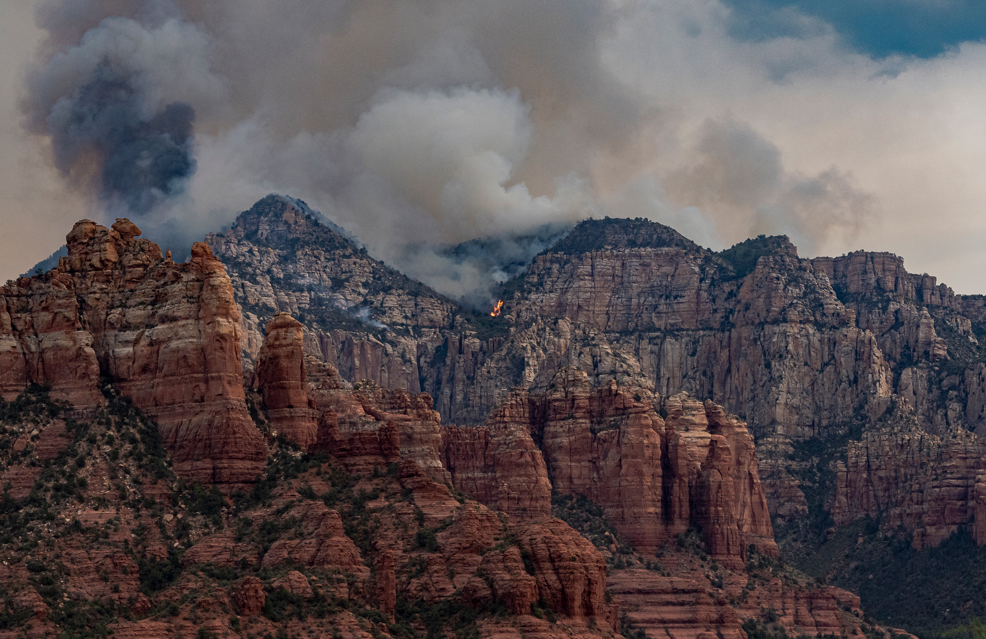 Flames emerging on lower flank of Munds Mountain