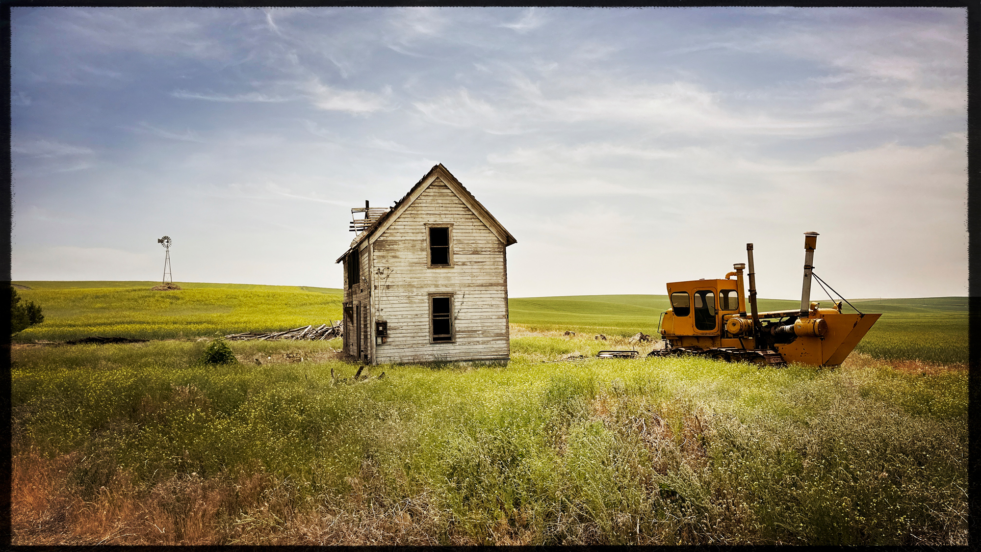 A Palouse classic. Windmill, House and tractor. The tractor hasn't moved in years. Why?