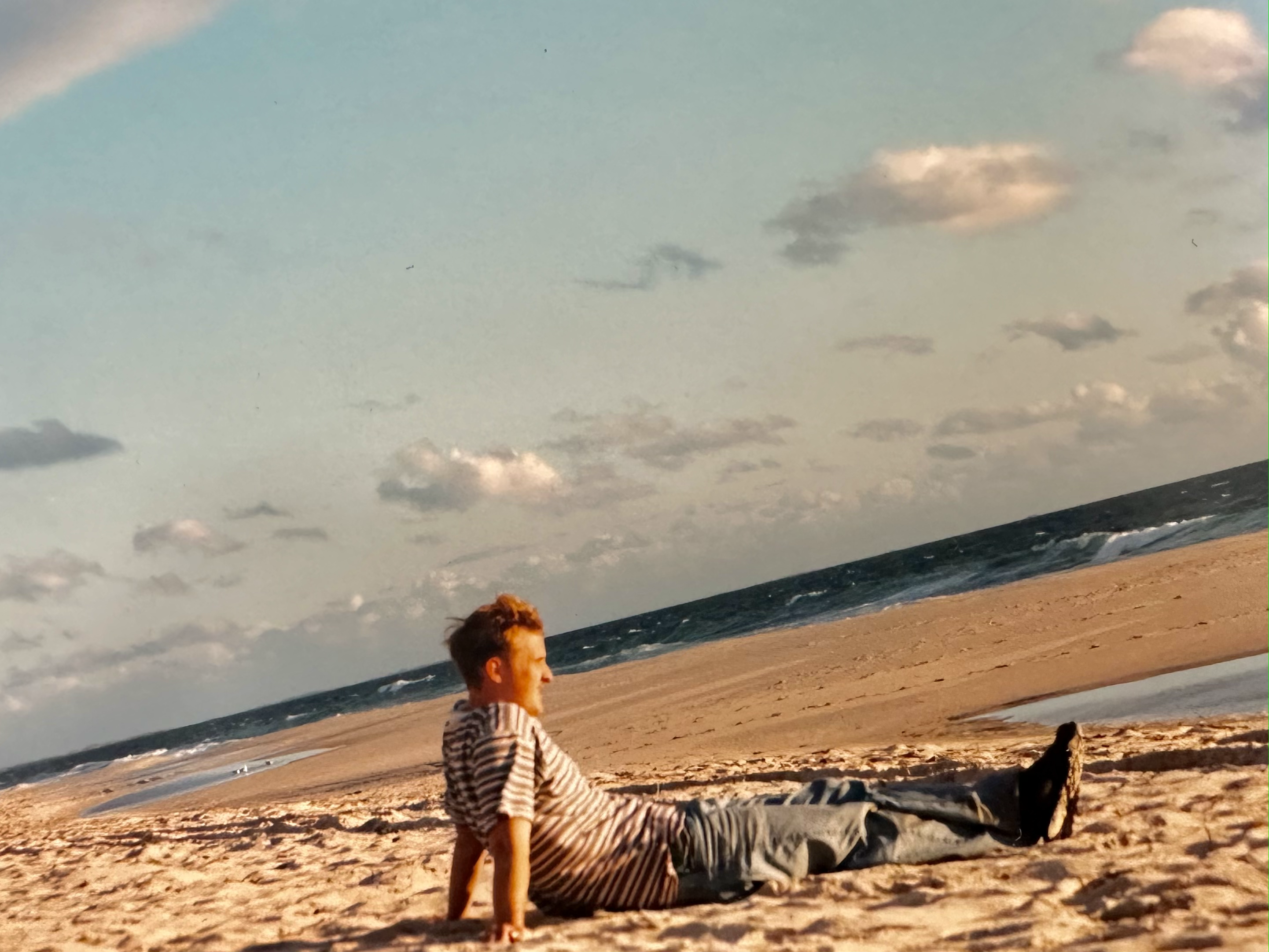 Jon Windall sitting on the beach in Australia
