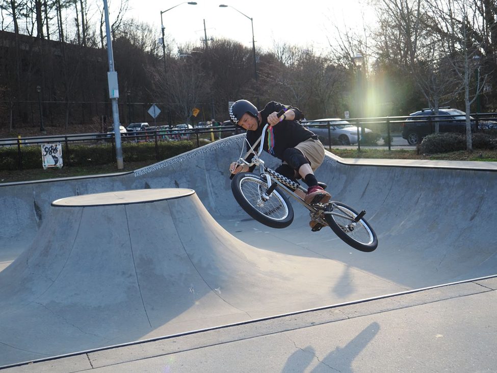 BMX rider mid-air at a skatepark, demonstrating action photography captured with the OM System OM-3 using Pro-Capture mode. The camera’s computational features freeze the dynamic movement, showcasing its potential for high-speed sports photography.