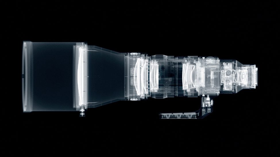 X-ray view of a professional telephoto camera lens, revealing internal optical elements and precision-engineered components for high-performance photography