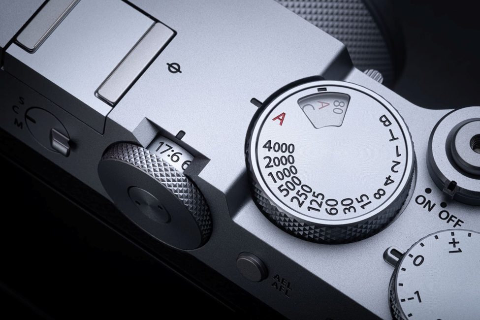 Close-up of the top dials on the Fujifilm GFX100RF, showcasing the vintage-inspired shutter speed dial, ISO control, and exposure compensation. The manual controls emphasize Fujifilm's commitment to a tactile shooting experience for professional photographers.