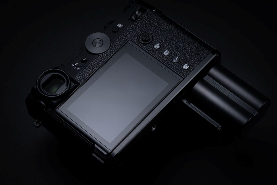 Rear view of the Fujifilm GFX100RF, showcasing its high-resolution LCD screen, intuitive control buttons, and dual-battery system for extended shooting. A professional-grade mirrorless medium format camera designed for photographers seeking power and ergonomics.