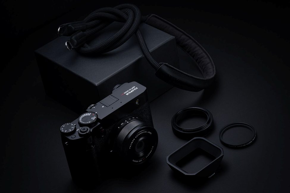 "Fujifilm GFX100RF premium mirrorless medium format camera with accessories, including a high-quality lens, lens hood, filters, and a durable camera strap. A professional setup designed for photographers seeking superior image quality and handling.