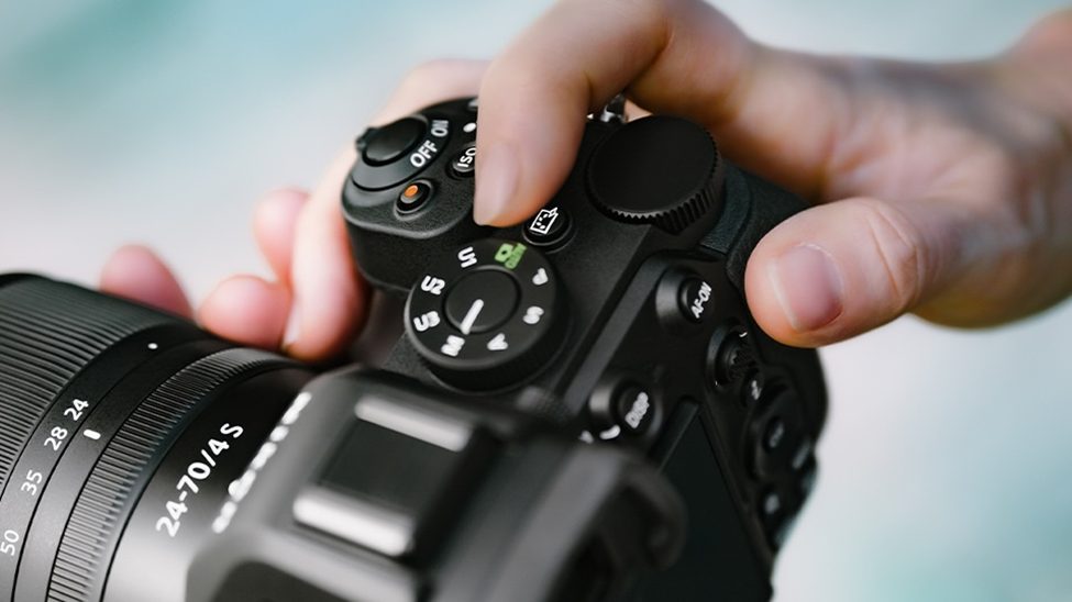 Close-up of a Nikon Z5 II mirrorless camera with NIKKOR Z 24-70mm f/4 S lens, highlighting controls and ergonomic design.