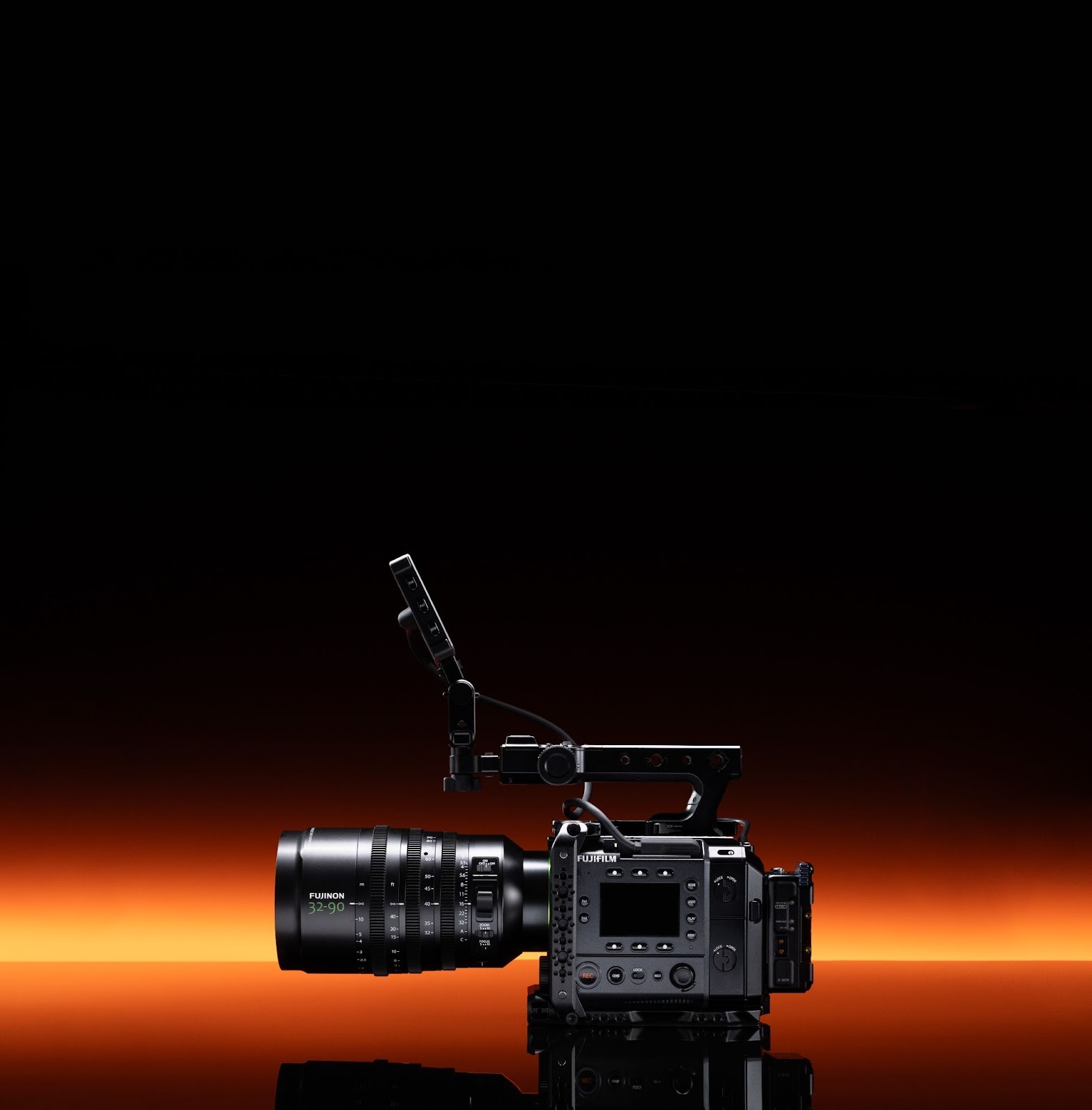 Side profile of the Fujifilm GFX Eterna cinema camera with a lens attached, highlighting the compact, boxy rig design, top handle, and various mounting points for professional filmmaking accessories.