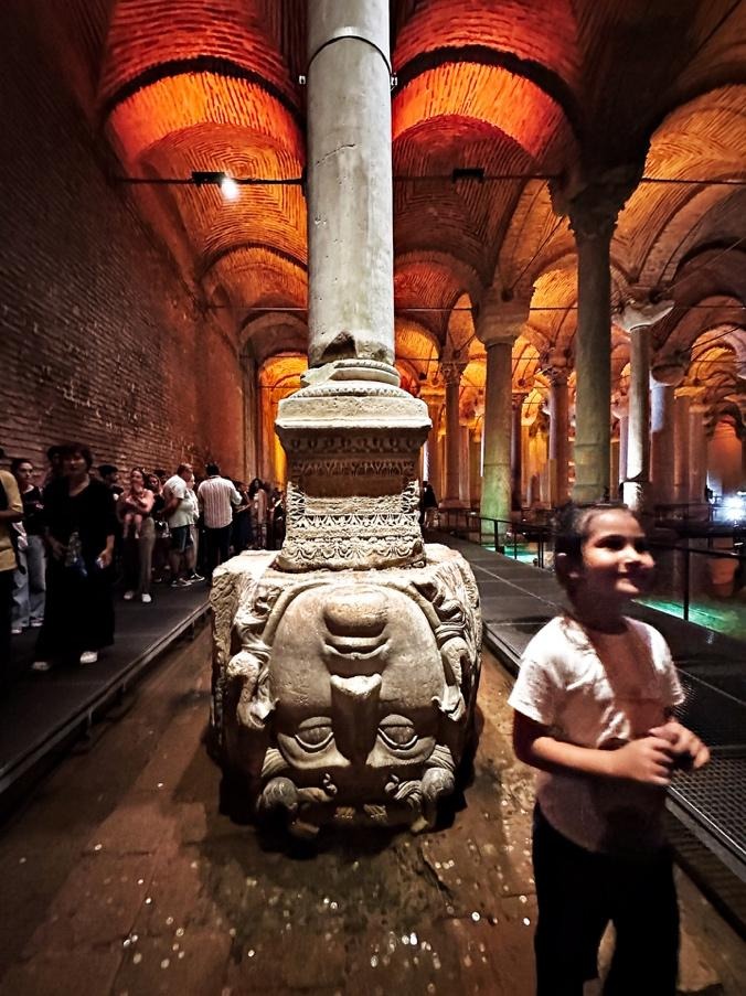 Medusa column base with child passing in Basilica Cistern Istanbul