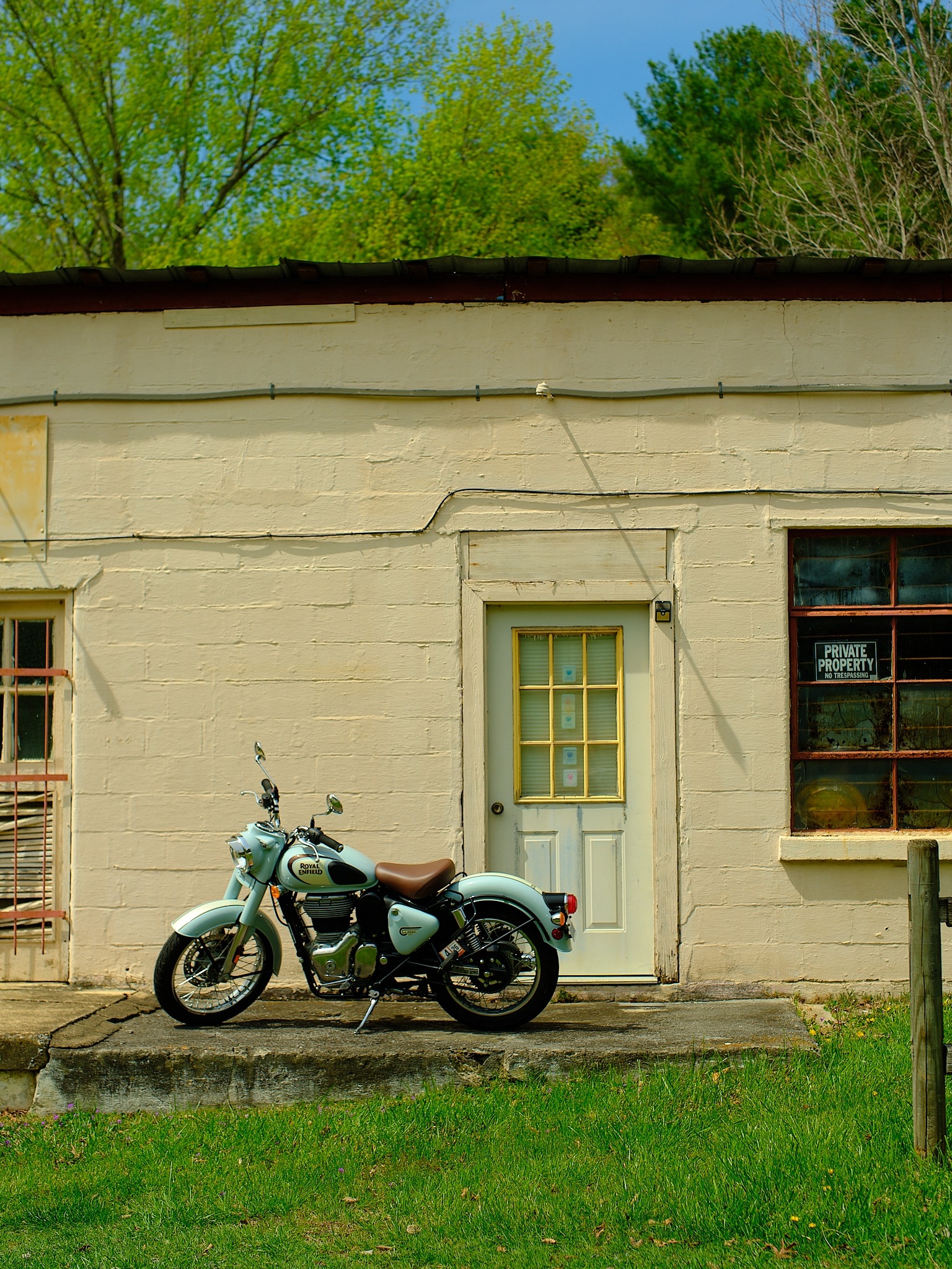 Vintage motorcycle parked in front of rustic building