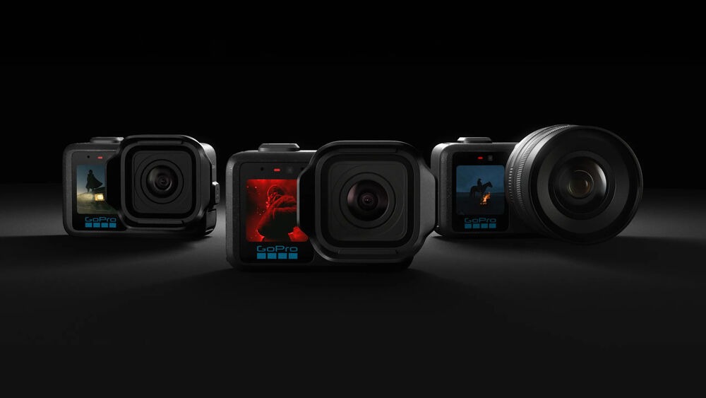 Three GoPro Mission 1 cameras lined up, including interchangeable lens model