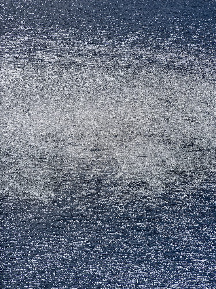 Blue water in Patagonia National Park, Chile, covered in silver reflective textures.