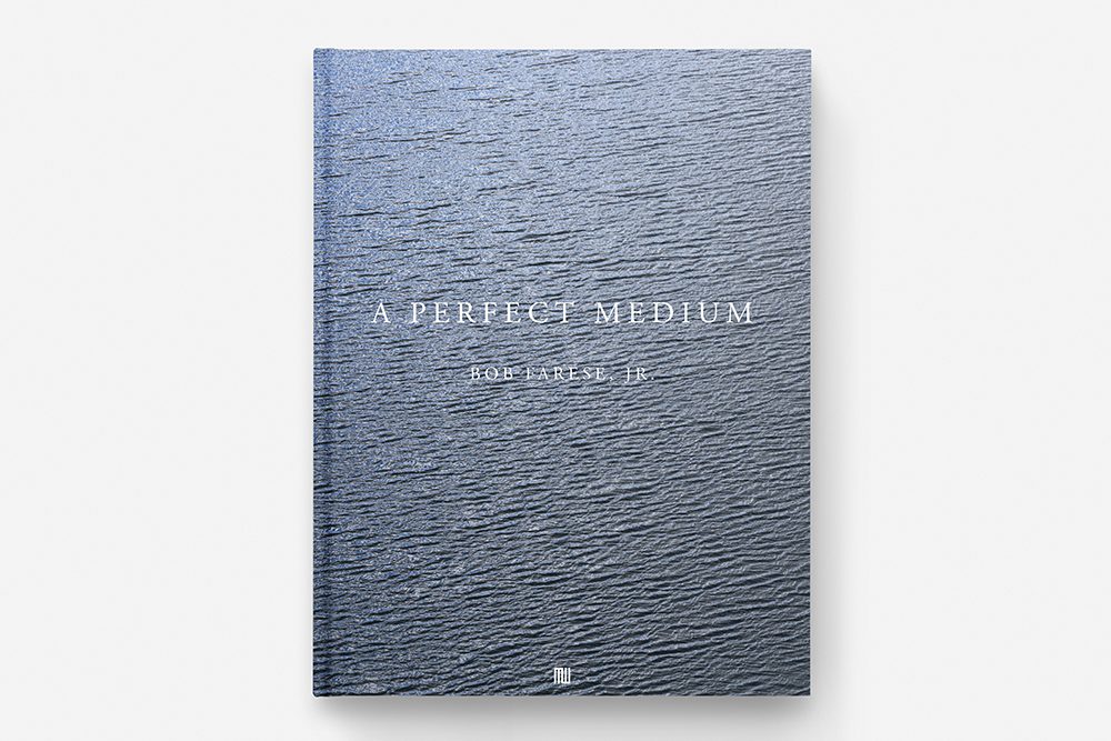 Book cover of A Perfect Medium featuring a textured blue water surface.