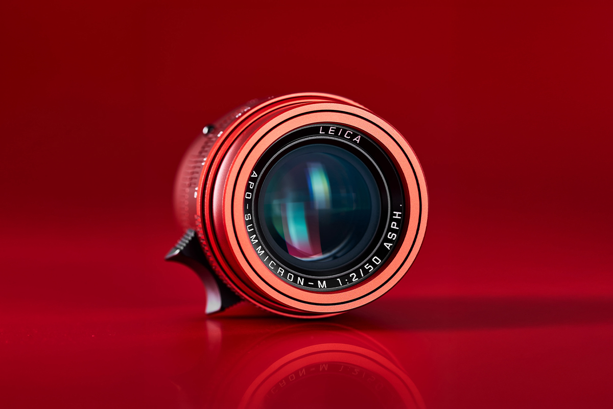 Red anodized Leica APO-Summicron-M 50mm lens on red background