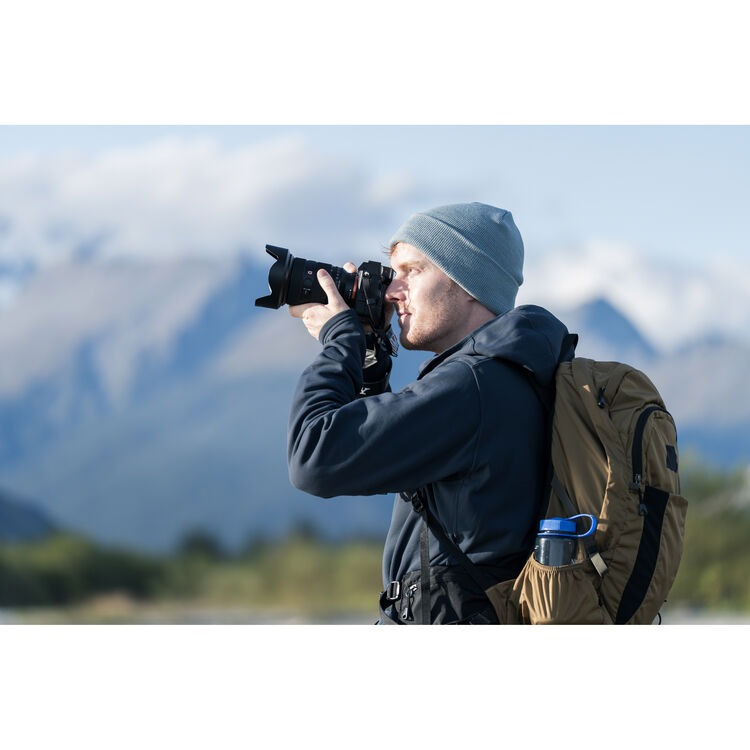 Photographer using Sony a7R VI outdoors in mountains