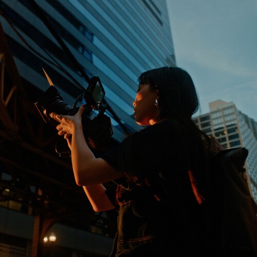 Creator filming outdoors with Canon EOS R6V in an urban setting