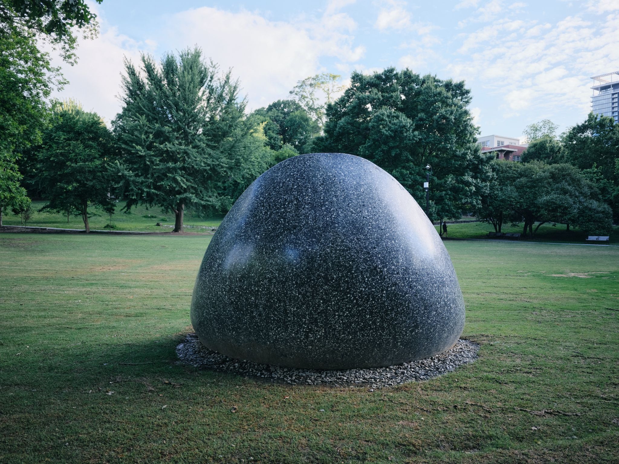 Large stone sculpture in a city park, highlighting GFX100RF landscape image quality