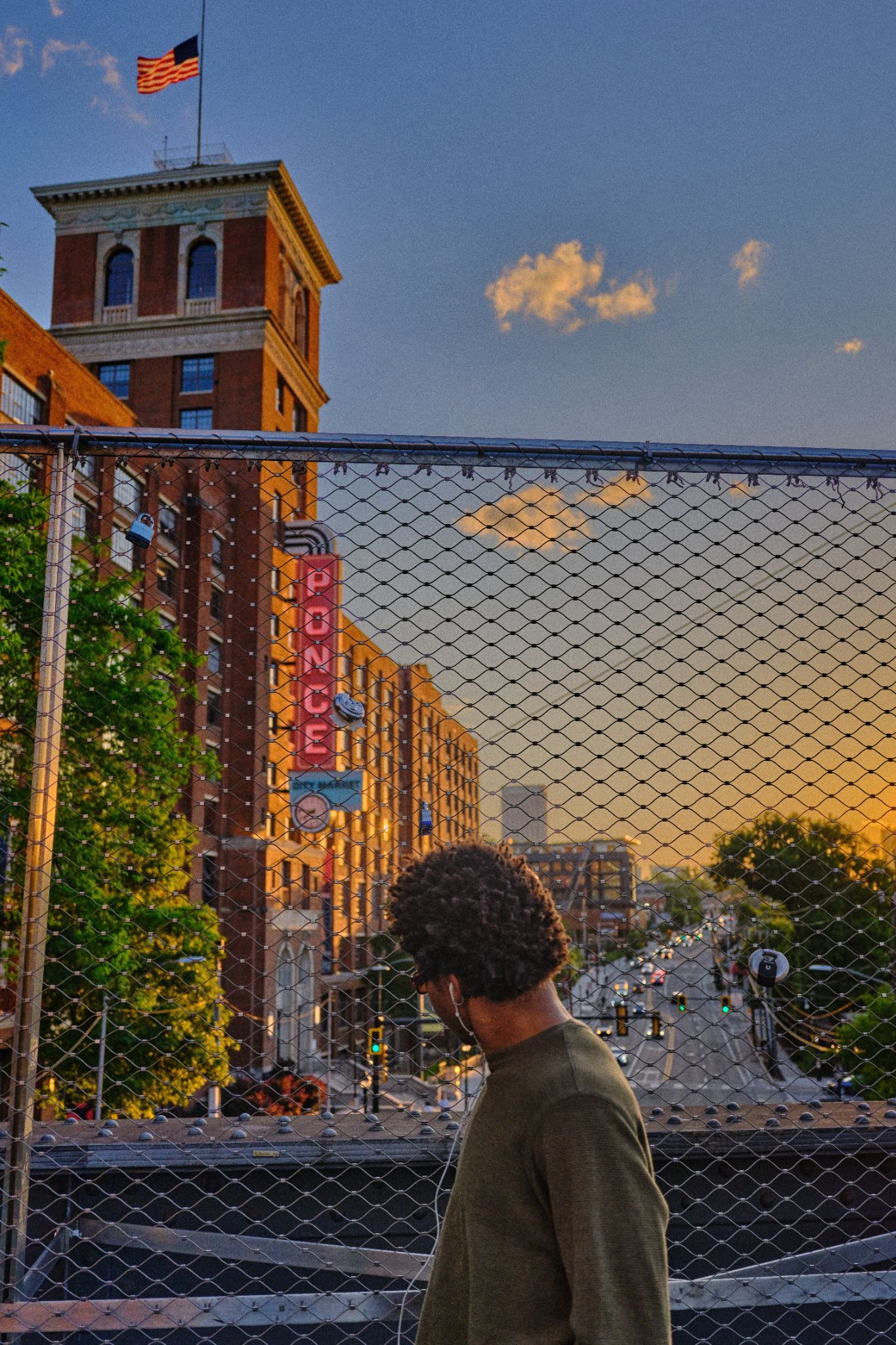 Person standing on a bridge at sunset, highlighting GFX100RF color and dynamic range