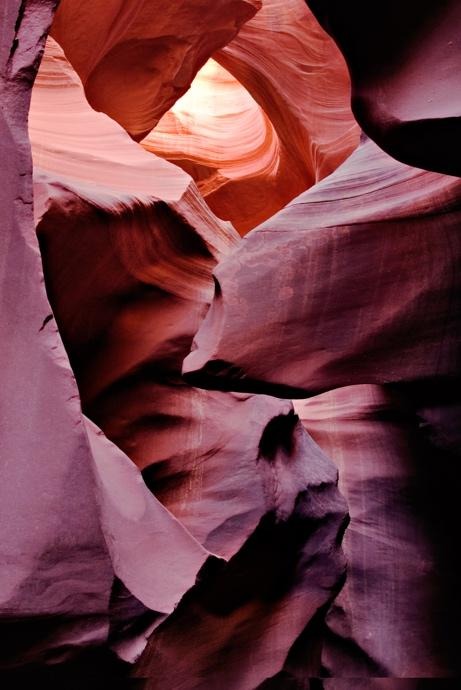 Abstract sandstone formations with pink and purple tones in a slot canyon