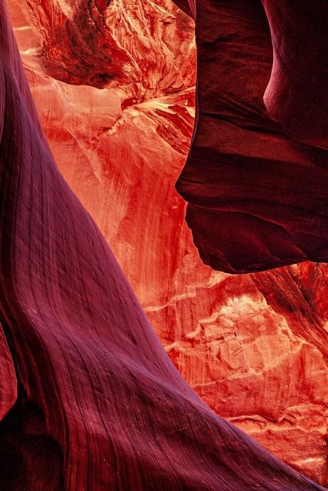 Dark canyon wall resembling a human profile against glowing sandstone