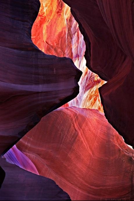 Layered red sandstone walls framed by deep canyon shadows