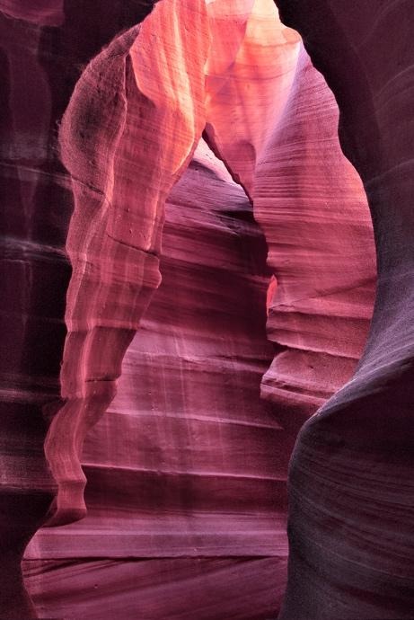Narrow sandstone passage with flowing pink and red canyon walls