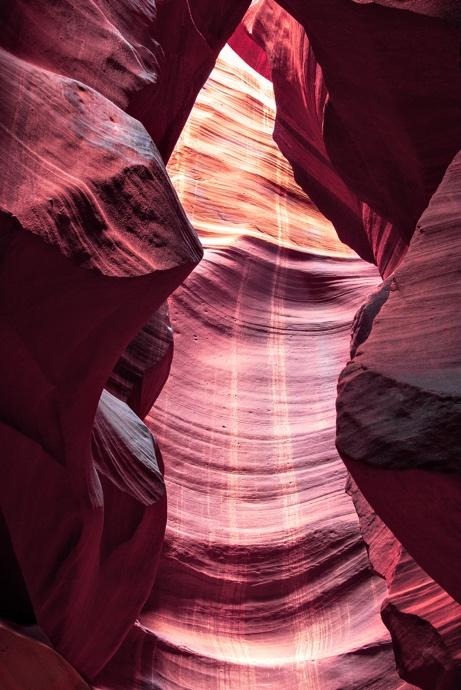 Sunlit slot canyon walls with striped sandstone patterns
