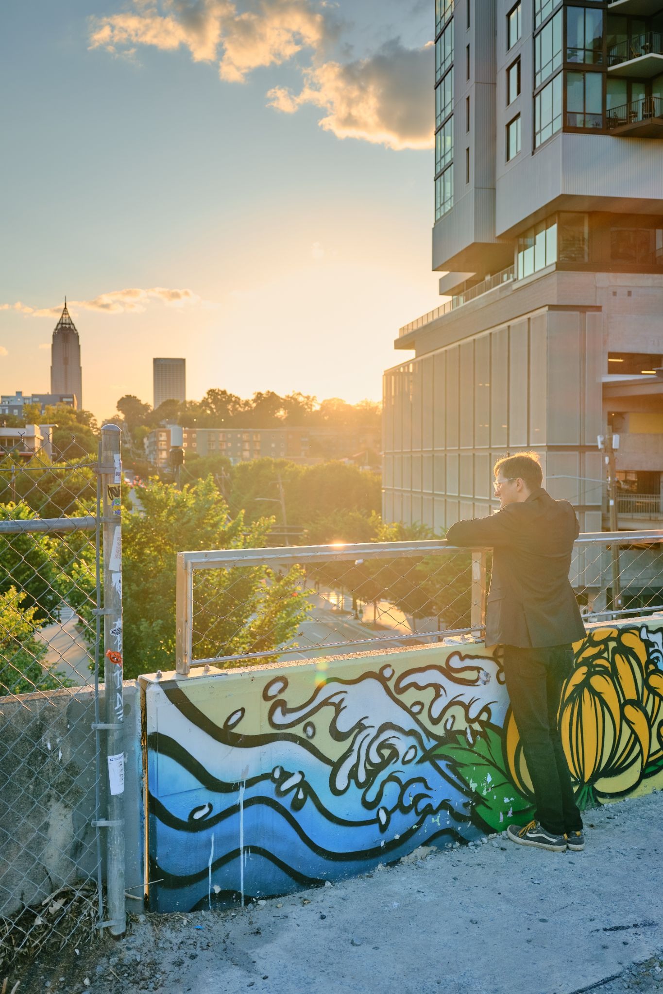 Person overlooking Atlanta skyline at sunset, showcasing GFX100RF environmental portrait quality