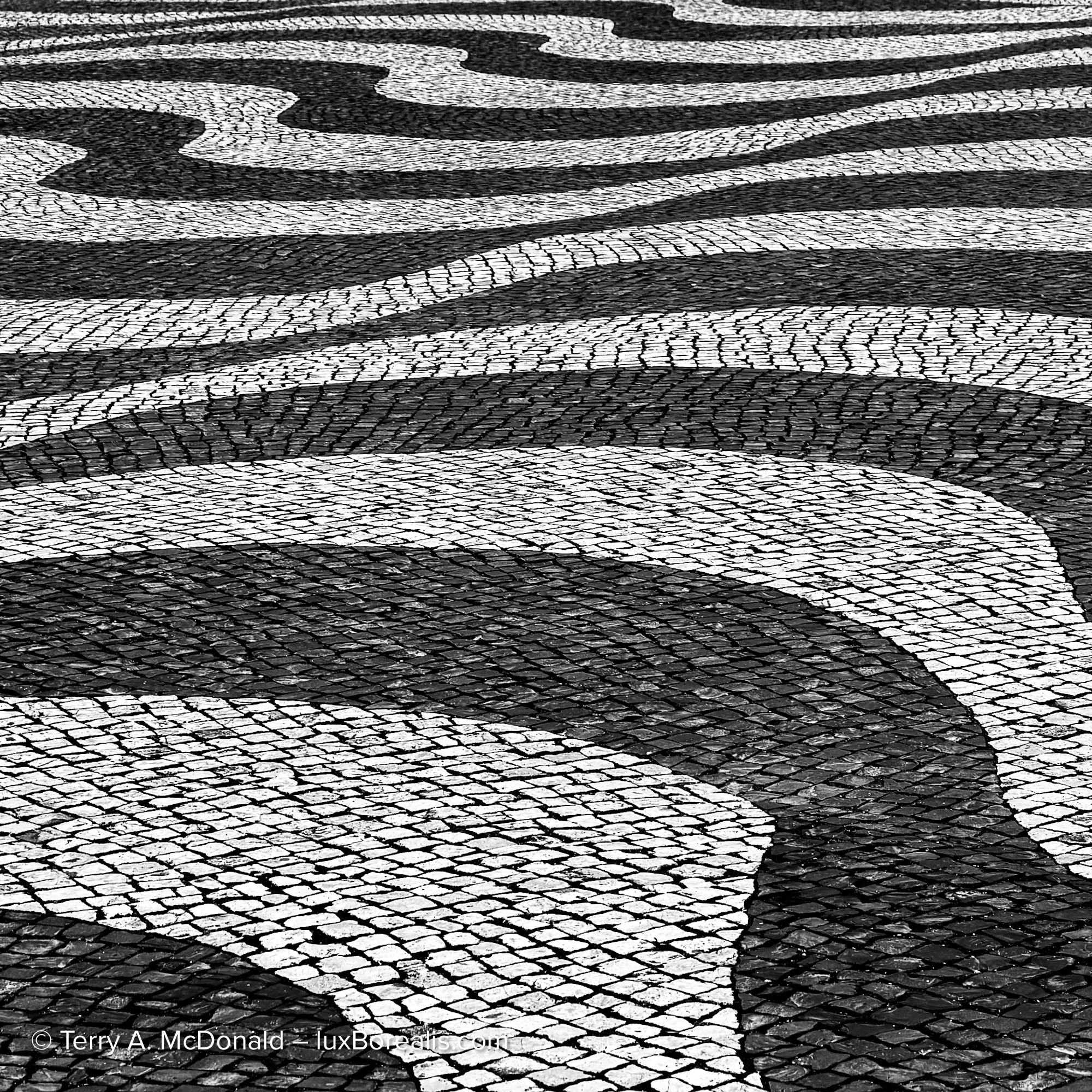 Black and white wave-pattern cobblestone pavement in Lisbon