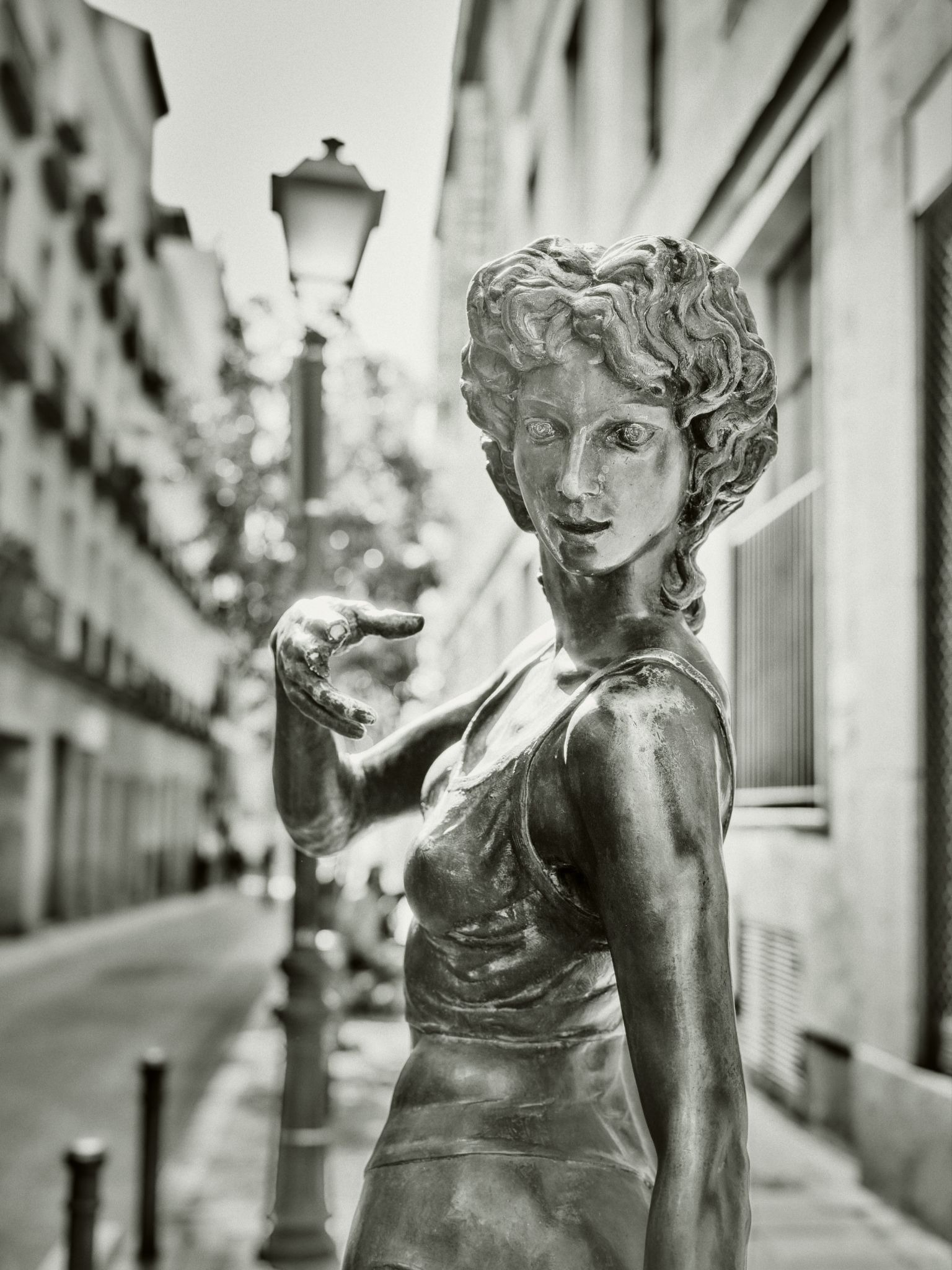 Bronze statue posing on a quiet street in Barcelona.
