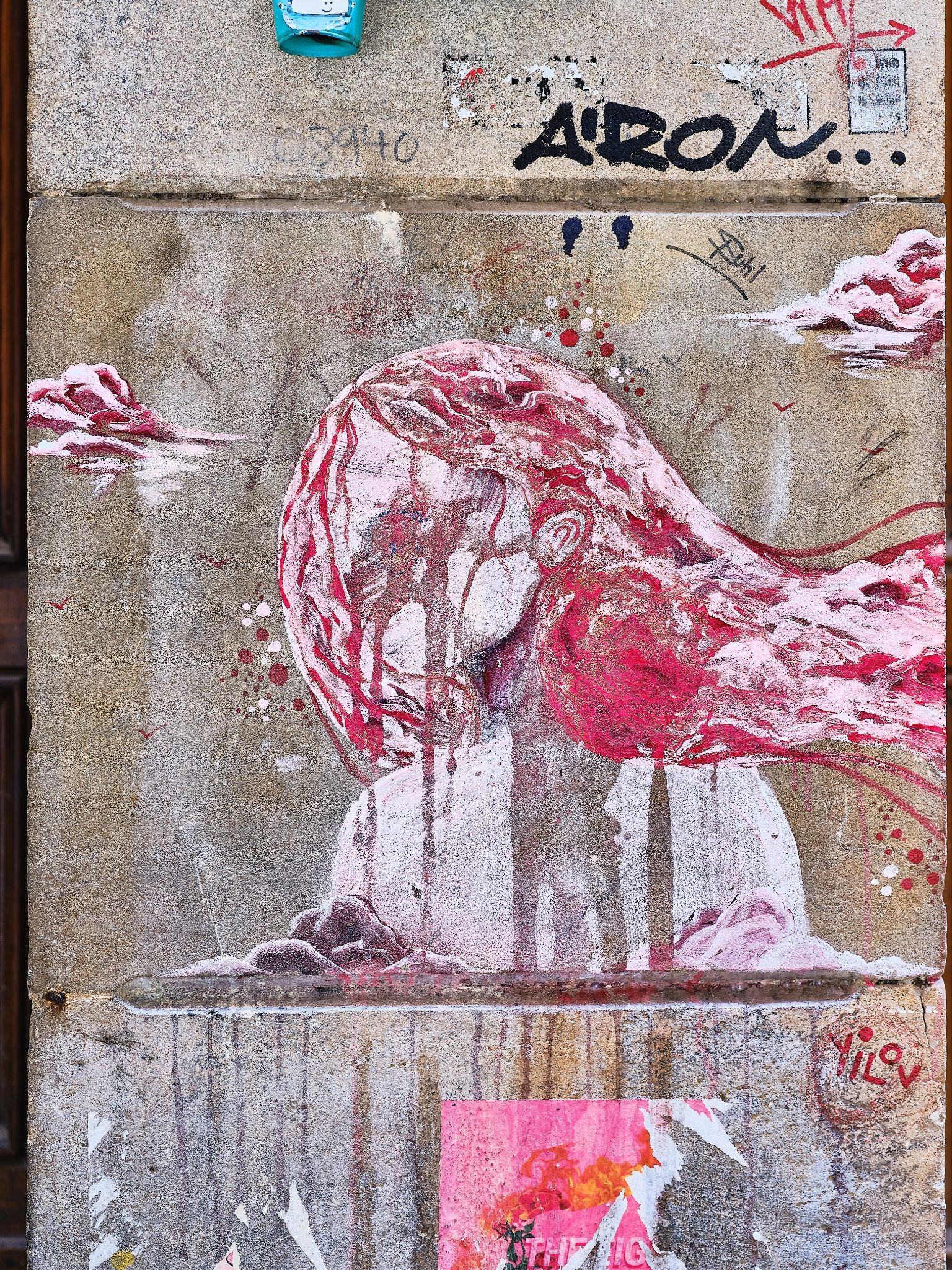 Street art mural of a flowing red-haired figure on a concrete wall.