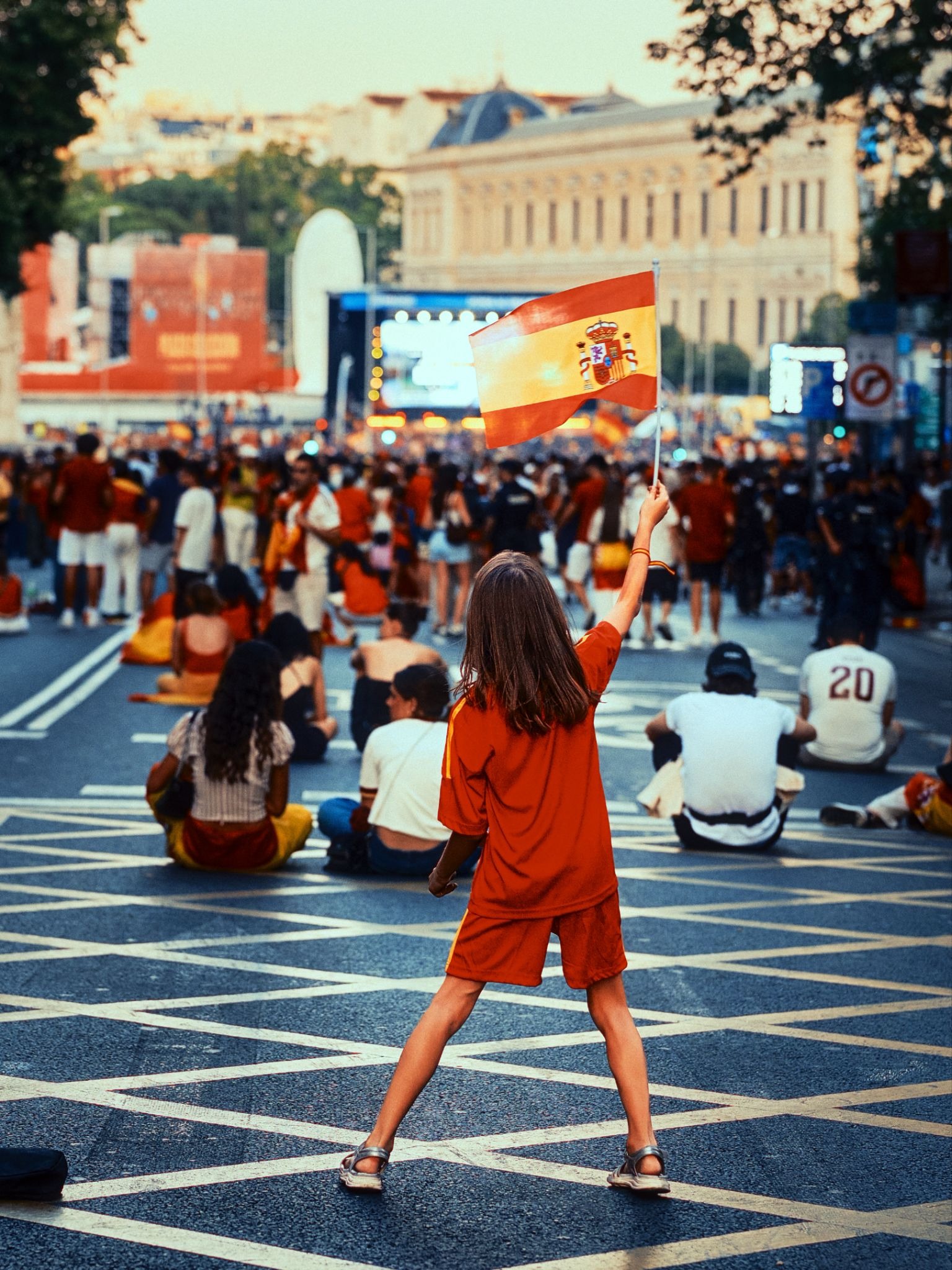 Child waving a Spanish flag during a World Cup celebration in Madrid.