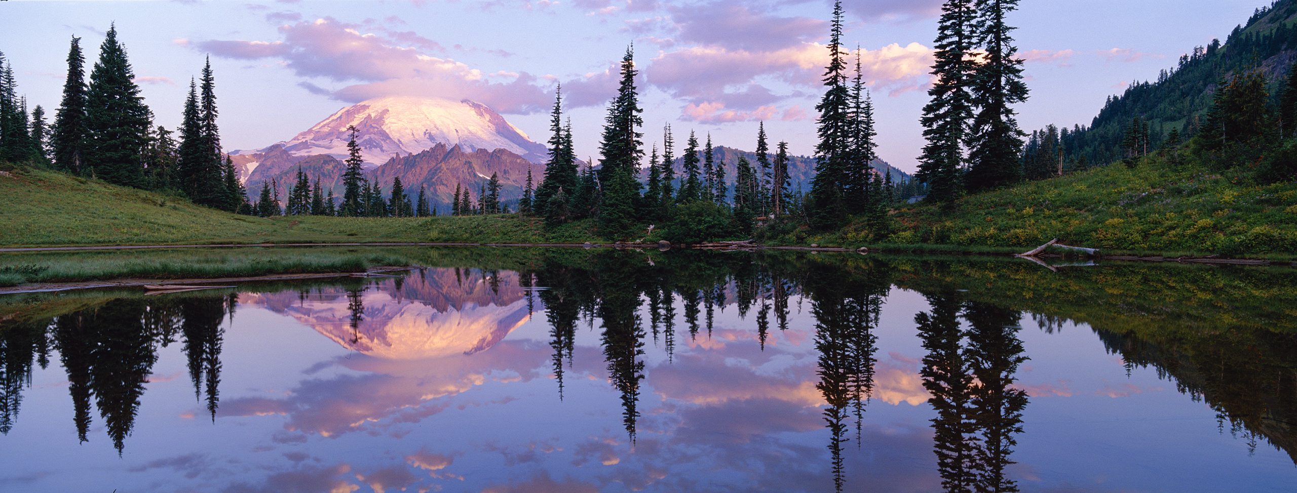 Mount Rainier rising above a calm reflective landscape in Washington State